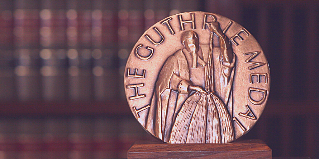 A round, bronze medal with the words "The Guthrie Medal" embossed on it.