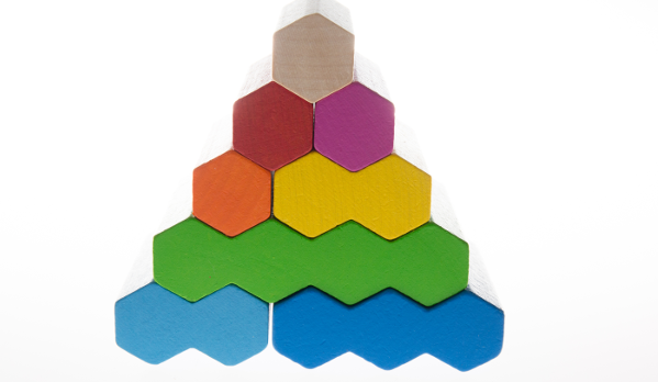 Colourful pyramid made out of stacked, hexagon blocks
