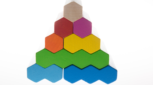A pyramid made out of colourful, hexagon wooden blocks
