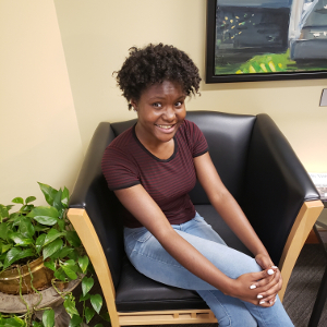 Young woman sitting in a chair, smiling