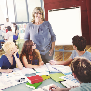 Woman leading conversation with group of young people