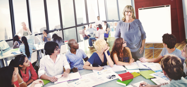 Woman leading conversation with group of young adults