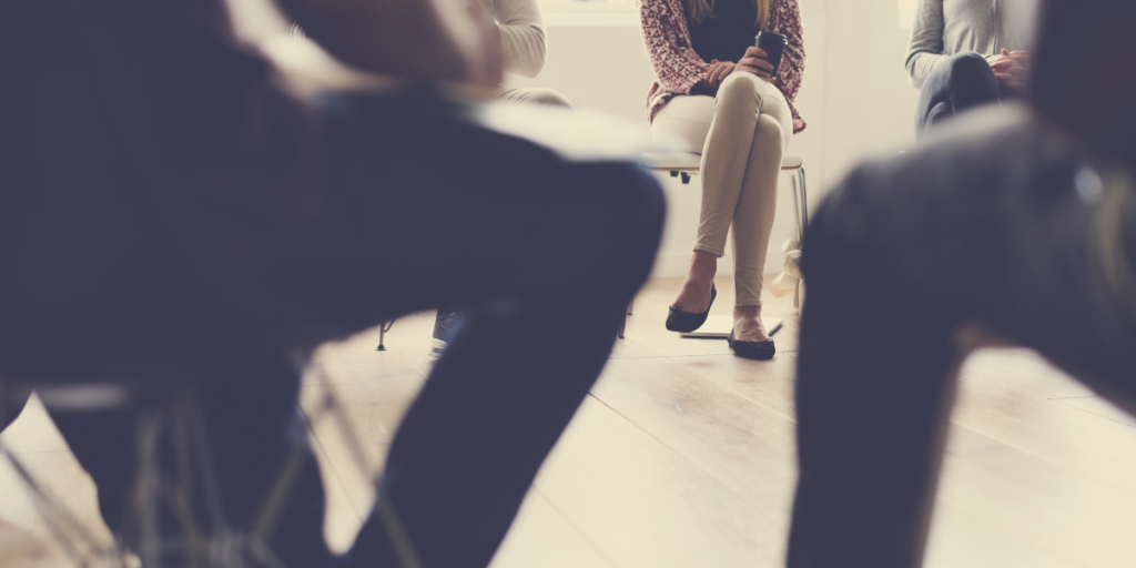 Group of people sitting on chairs arranged in a circle