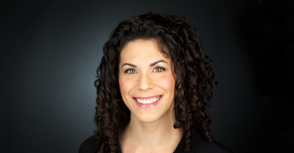 Smiling woman with dark curly hair