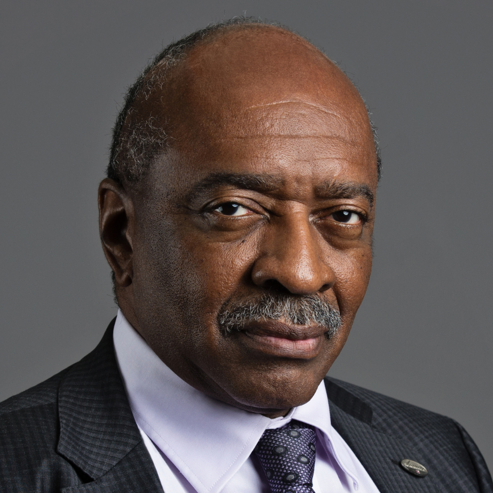 Man with dark mustache wearing dark suit
