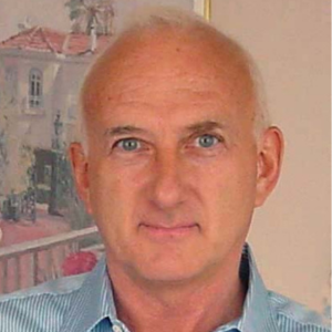 Man with very short white hair, wearing a blue striped shirt
