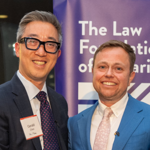 Gerald, who has short black hair and dark glasses, and Bennett, a man with very short brown hair